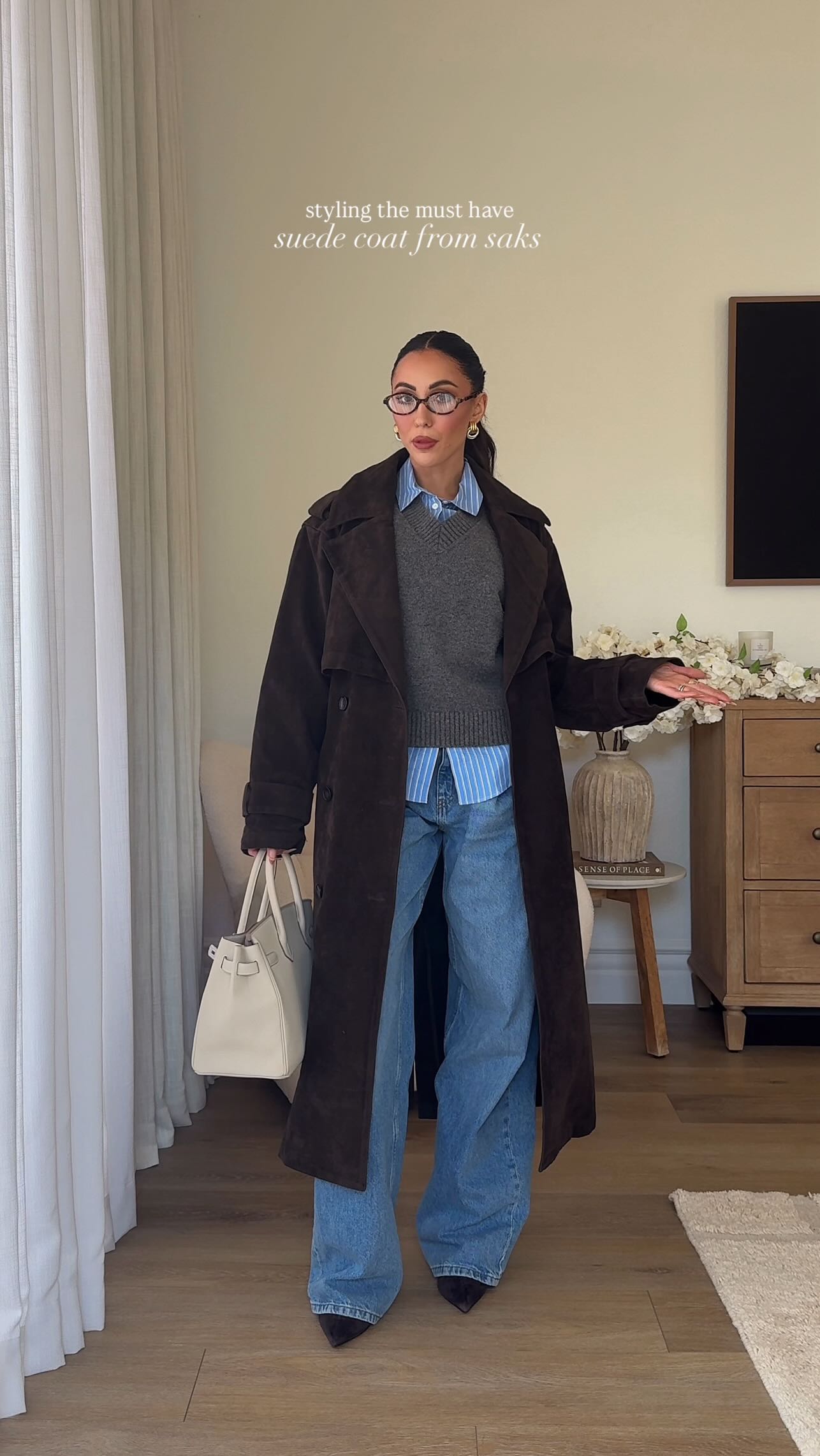 Instagram post by @madeline_devaux for Saks Fifth Avenue. Caption reads: Meet your new Fall uniform 🤎This suede trench is....