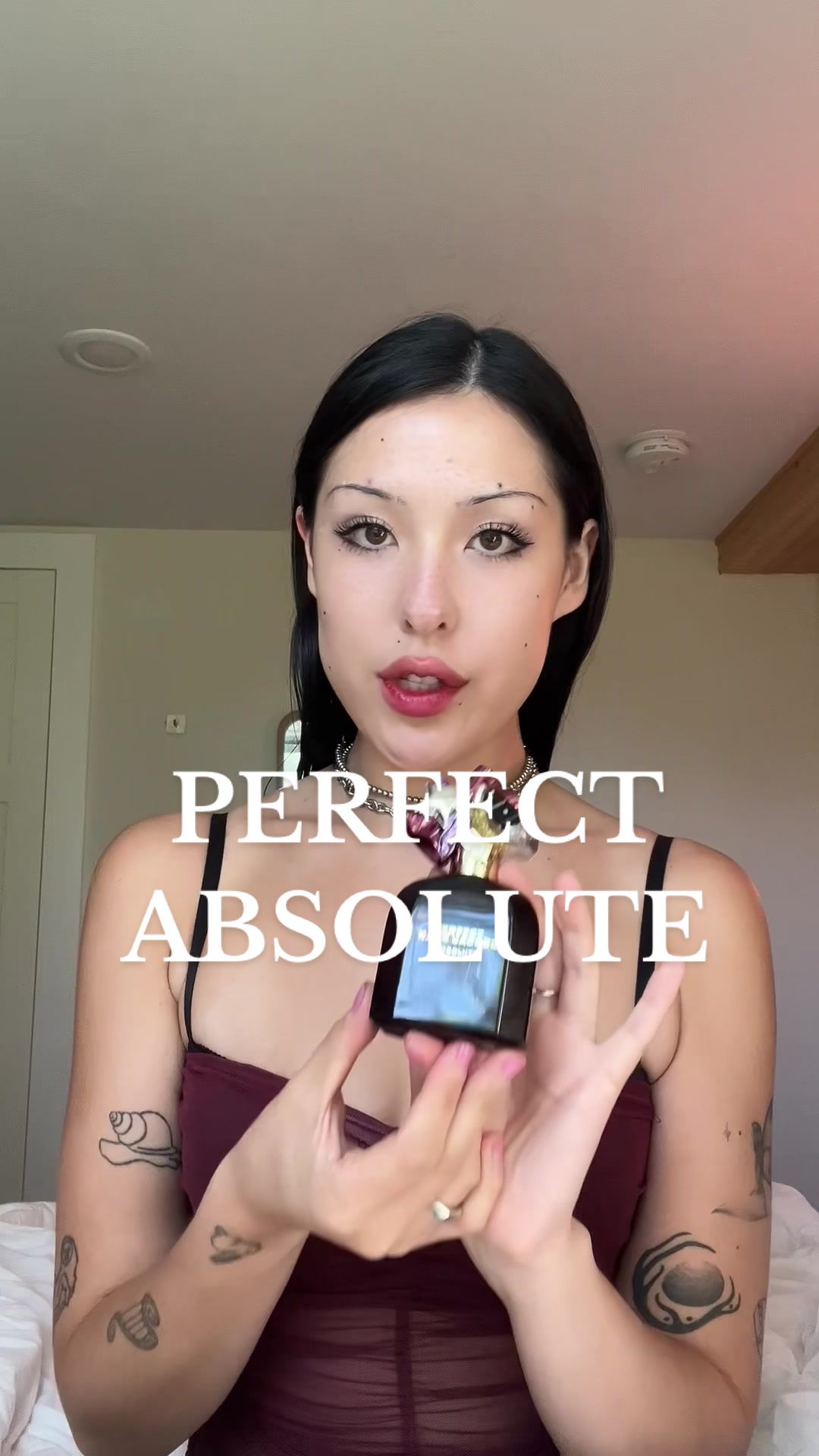 TikTok post by @cammyreviews for Marc Jacobs Fragrances. Caption reads: The elegant and delicious new Perfect Absolute....