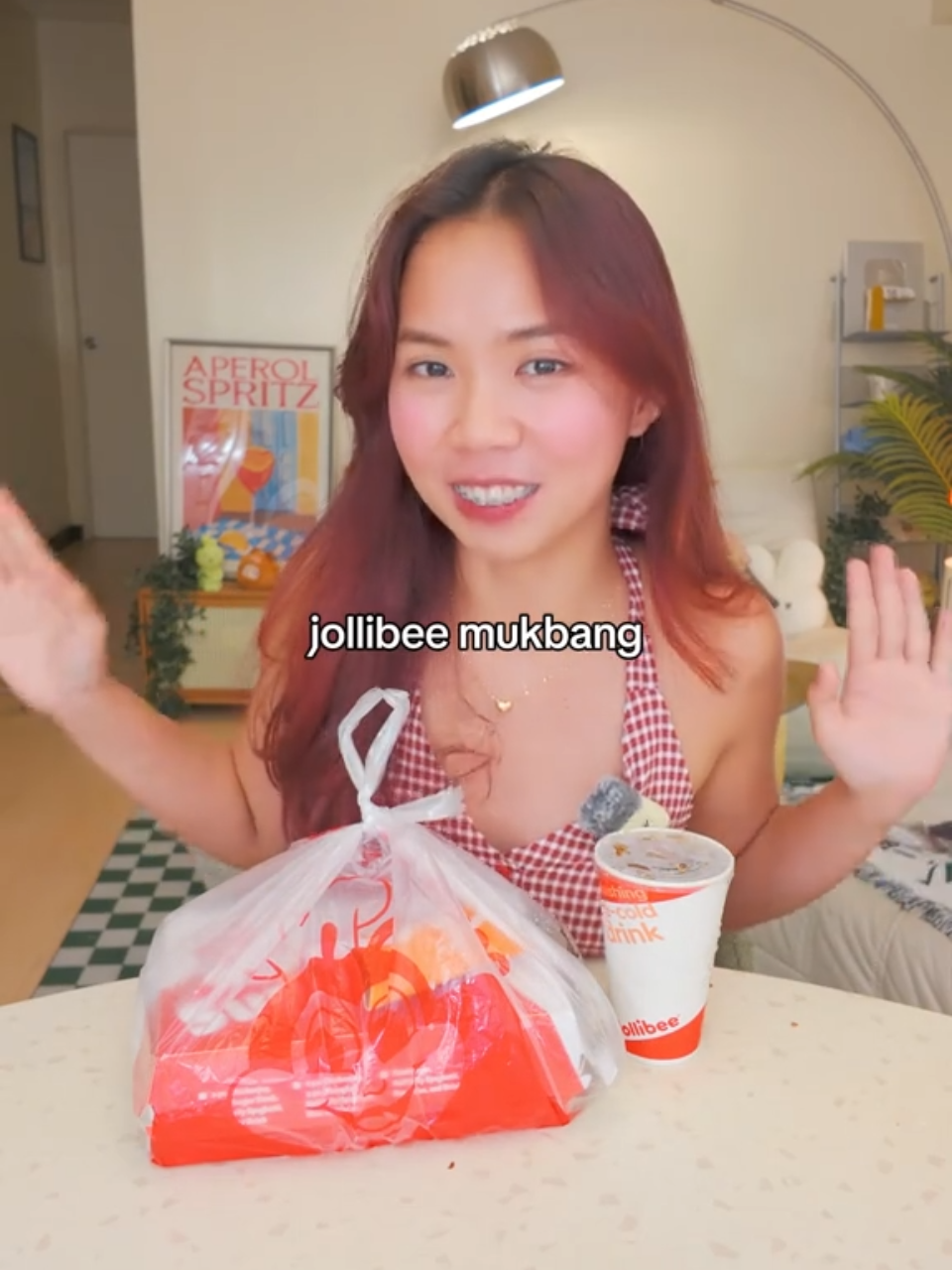 TikTok post by @chelgania for Jollibee. Caption reads: [...] reward in one plate. 🍗🍝🍔....