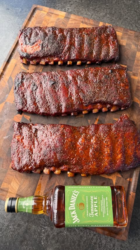 Instagram post by @cooking_with_fire___ for Jack Daniel's. Caption reads: #ad These Jack Apple Smoked Ribs with....