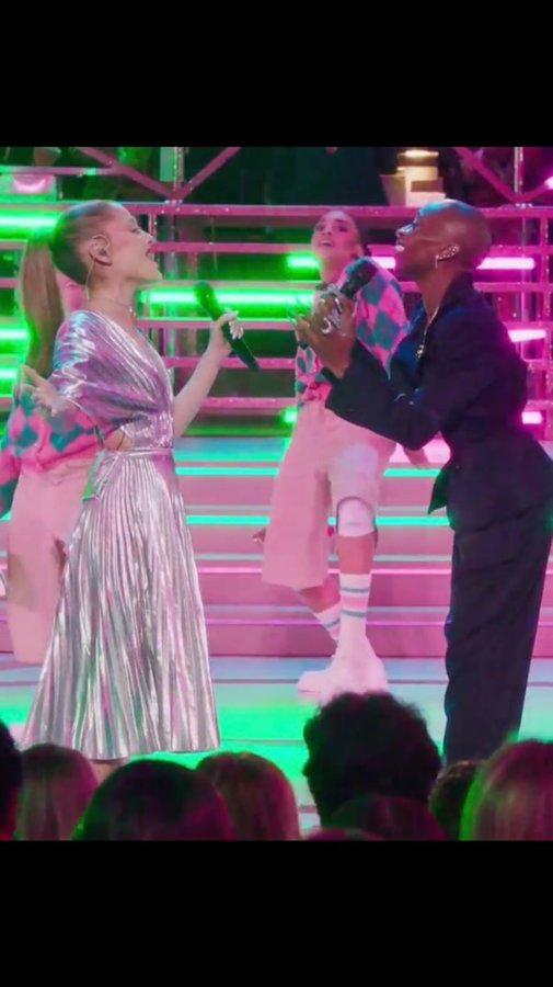 Instagram post by @arianagrande for Peacock. Caption reads: These vocals: so pure, so strong! 💚 🩷 Wicked:....