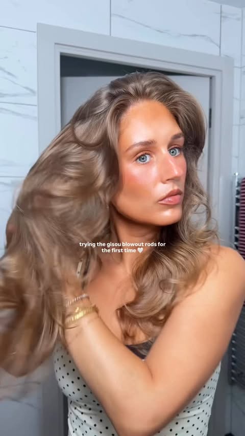 Instagram post by @byemmaleah for Gisou. Caption reads: trying the gisou heatless blowout rods for the....