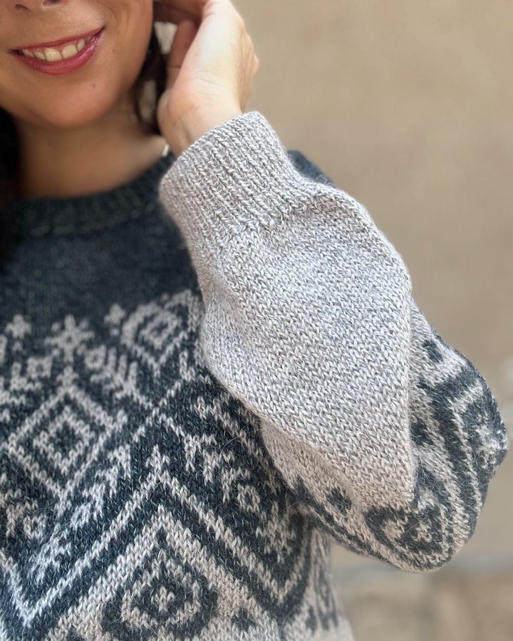 Instagram post by @celine.knits for Universal Yarn. Caption reads: 🎉It’s launch day for the Heart Prism Pullover....