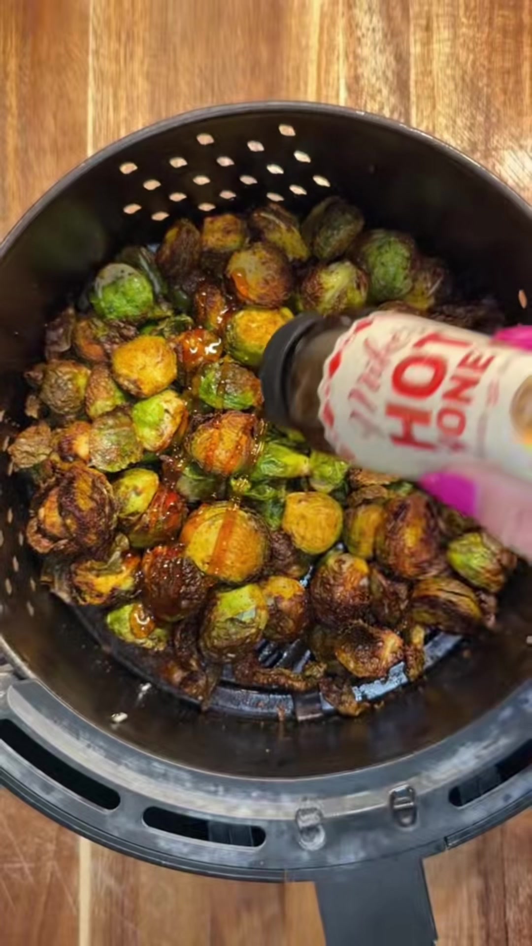 TikTok post by @amdhomemade for Mike's Hot Honey. Caption reads: [...] Honey Air Fried Brussel Sprouts 🔥🍯....