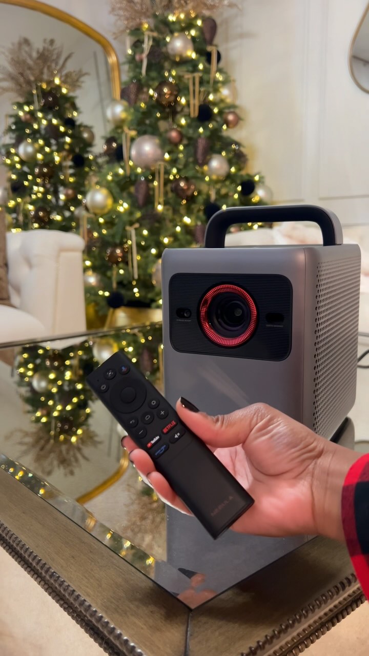 Instagram post by @islandgal_5homedecor for NEBULA. Caption reads: Get a projector and take movie nights at home to....