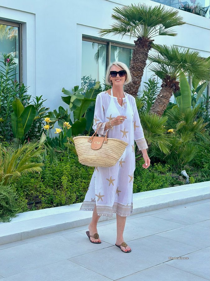 Instagram post by @stripeycoral for Aspiga. Caption reads: [...] kaftan/tunic and disc leather sandals....