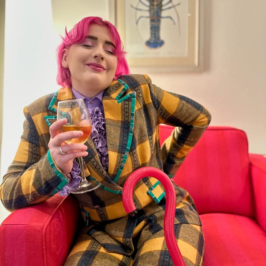 Instagram post by @disabled_eliza for Celia B. Caption reads: [...] fizzy grape juice instagram🍇

Suit:....