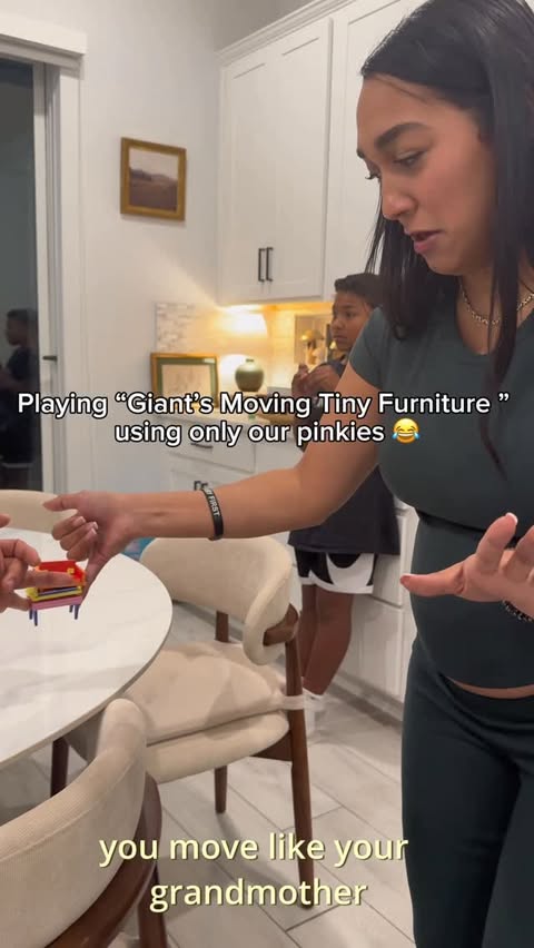 Instagram post by @ashleyannel for Exploding Kittens. Caption reads: Family game night playing “Giants Moving Tiny....