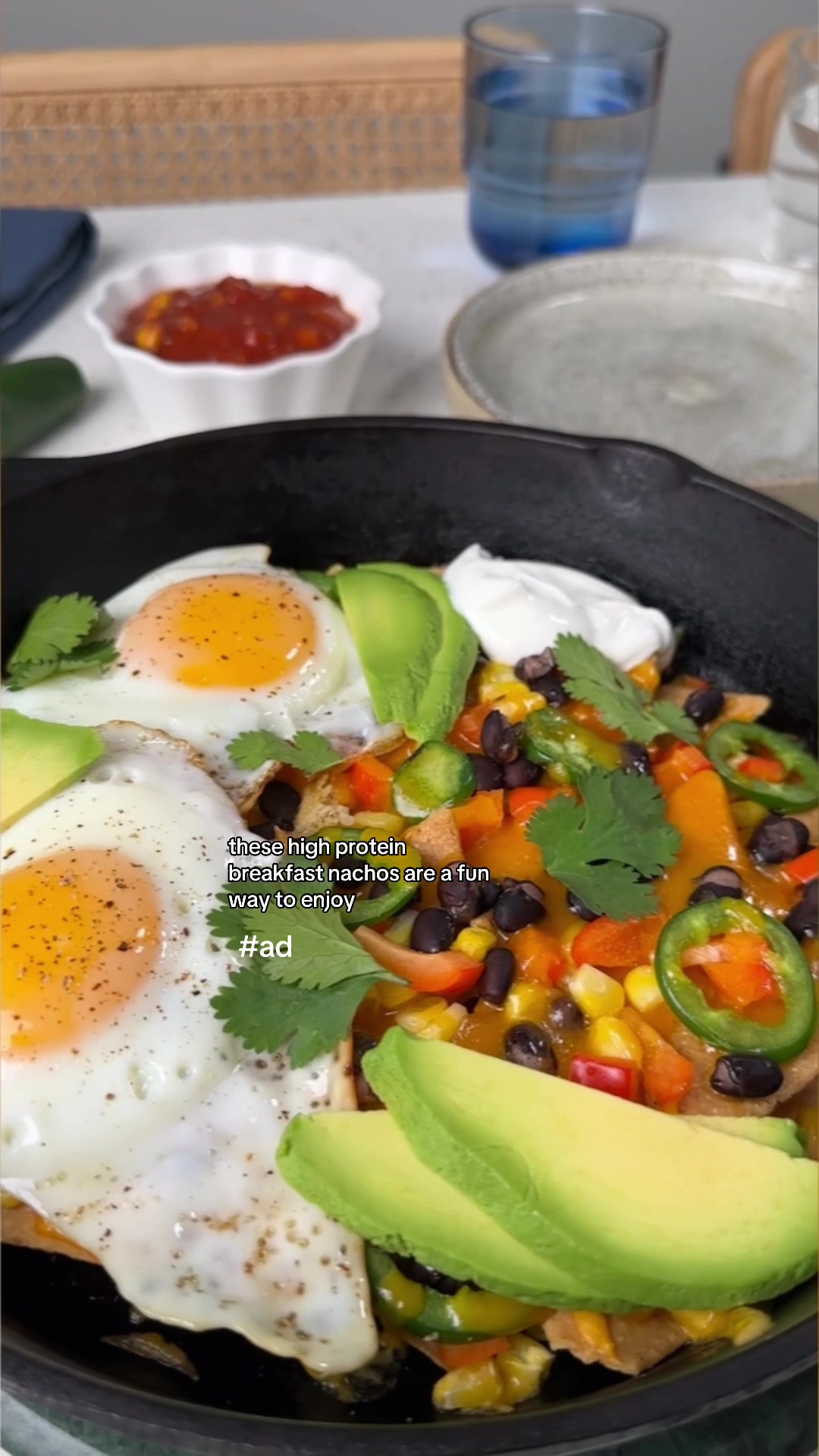 TikTok post by @kimthefoodie for SimplyProtein. Caption reads: #ad Easy breakfast nacho skillet using tortilla....