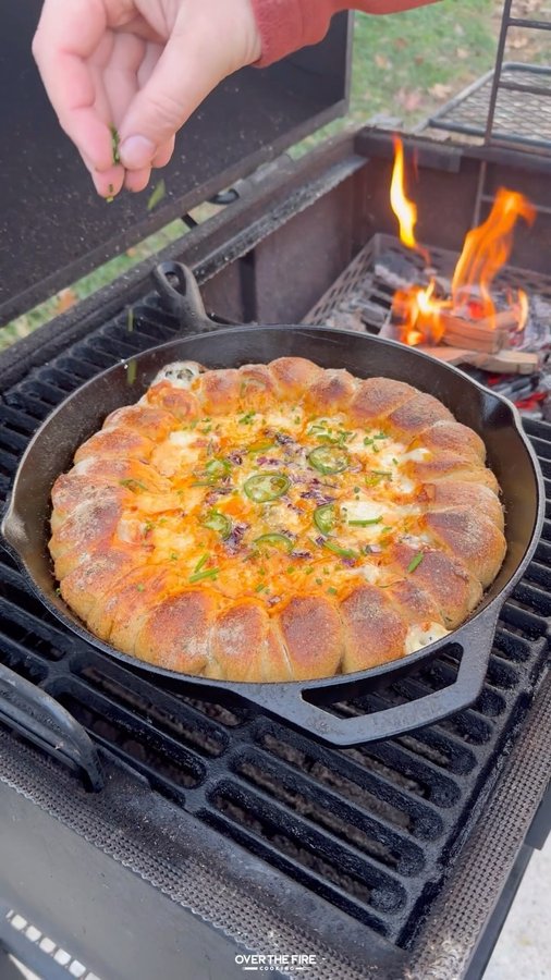 Instagram post by @overthefirecooking for Oklahoma Joe's. Caption reads: [...] Chicken Dip with Stuffed Crust with....
