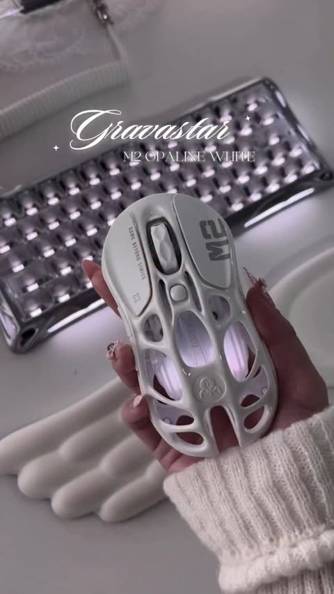 Instagram post by @cygneix for GravaStar. Caption reads: gravastar finally released a white mouse, war is....