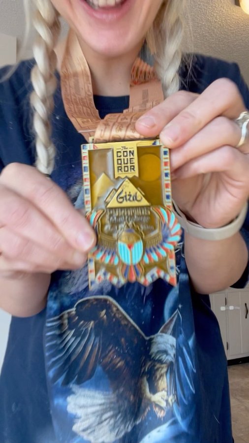 Instagram post by @katiemariebakeryqueen for The Conqueror Virtual Challenges. Caption reads: #ad IM SO EXCITED to share this app! With four....