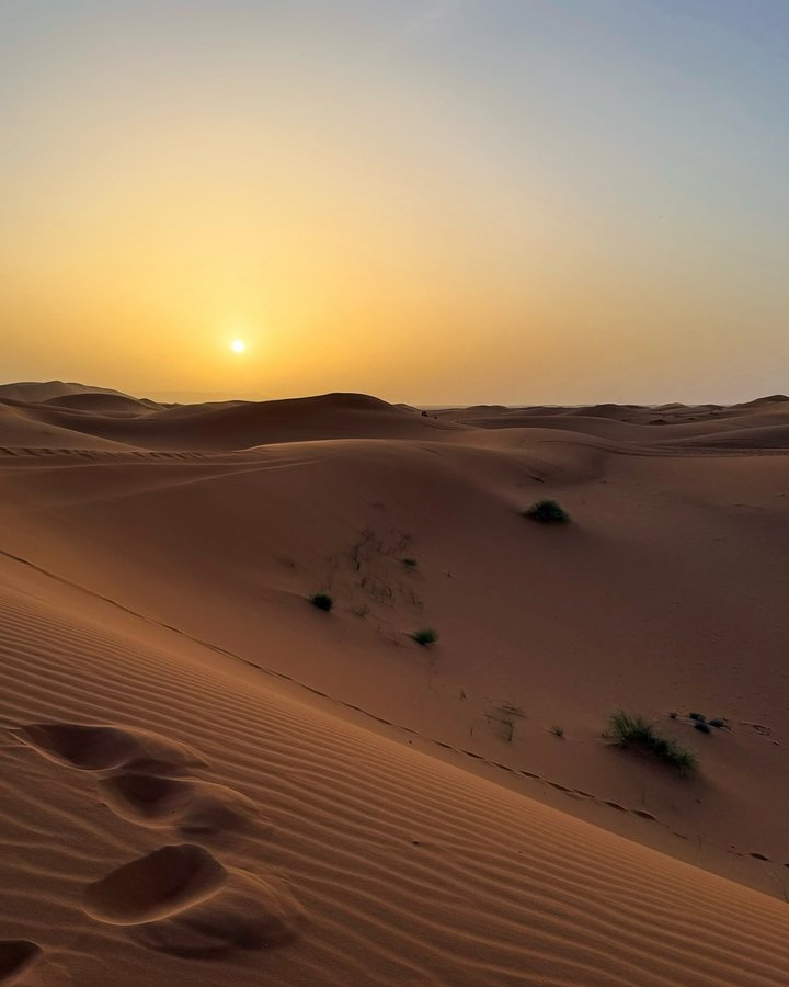 Instagram post by @globetrotterswanderlust for Femme Luxe. Caption reads: The Sahara Desert — where every moment feels like....