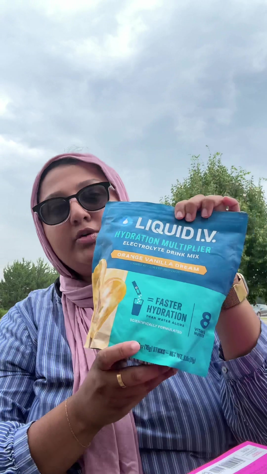 TikTok post by @aymansbooks for Liquid IV. Caption reads: Orange Vanilla Dream + a Jasmine Guillory novel =....