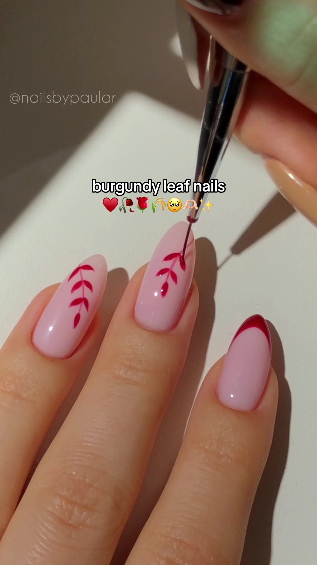 TikTok post by @nailsbypaular for MelodySusie. Caption reads: burgundy leaf nails! ♥️🌹🥀 a minimalistic autumn....