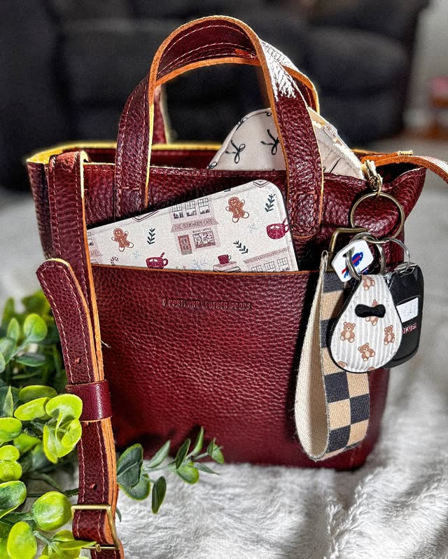 Instagram post by @hookedon_booksncoffee for Portland Leather Goods. Caption reads: How stunning is my new nutmeg mini crossbody tote....