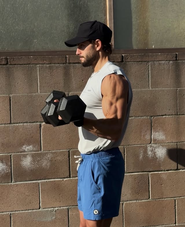 Instagram post by @colewinarick for Vuori. Caption reads: [...] Row - Curl to Shoulder Press Kit from....