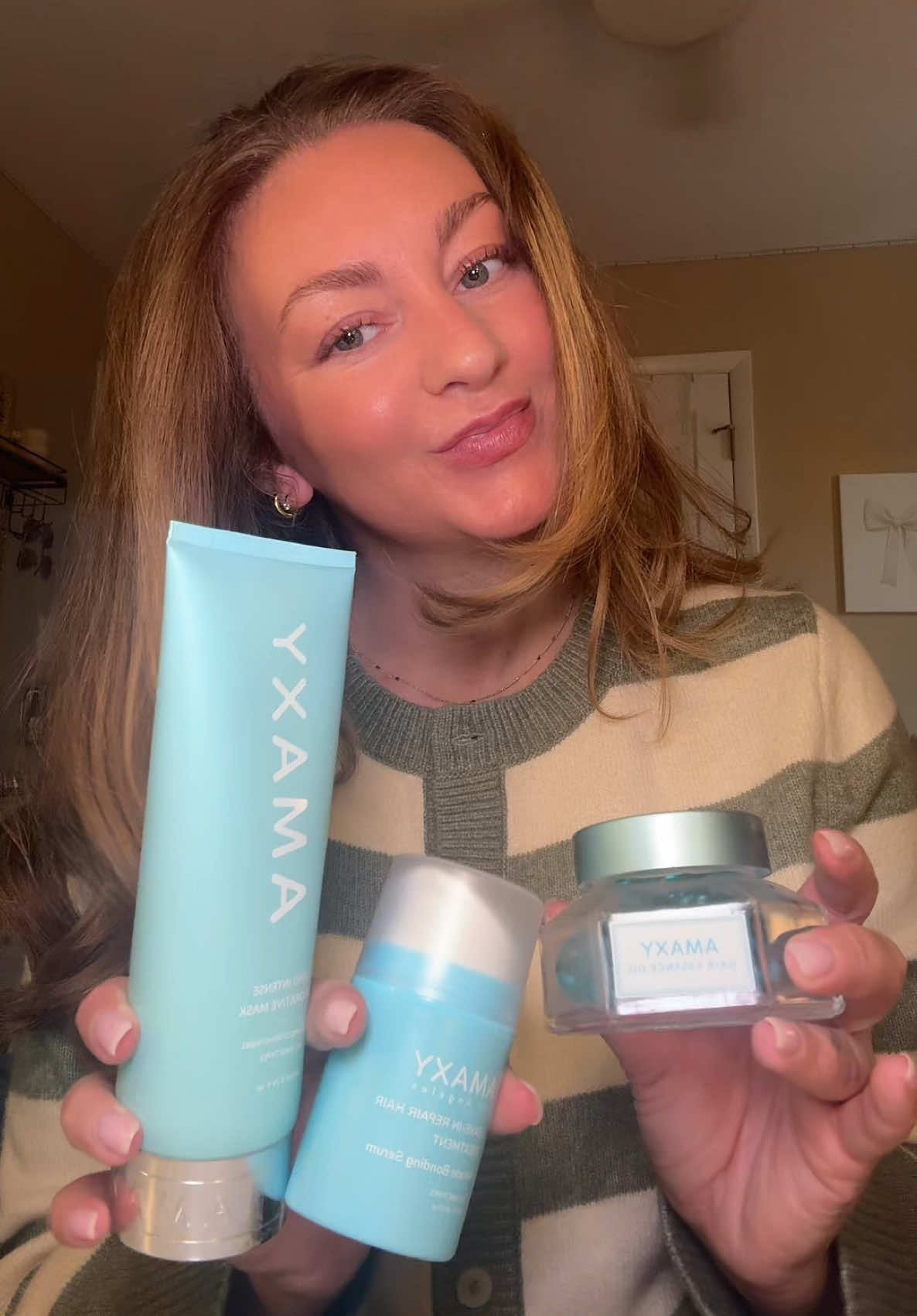 TikTok post by @juliannepeer for AMAXY Beauty. Caption reads: [...] help of @AMAXY Haircares 🩵 #amaxy....