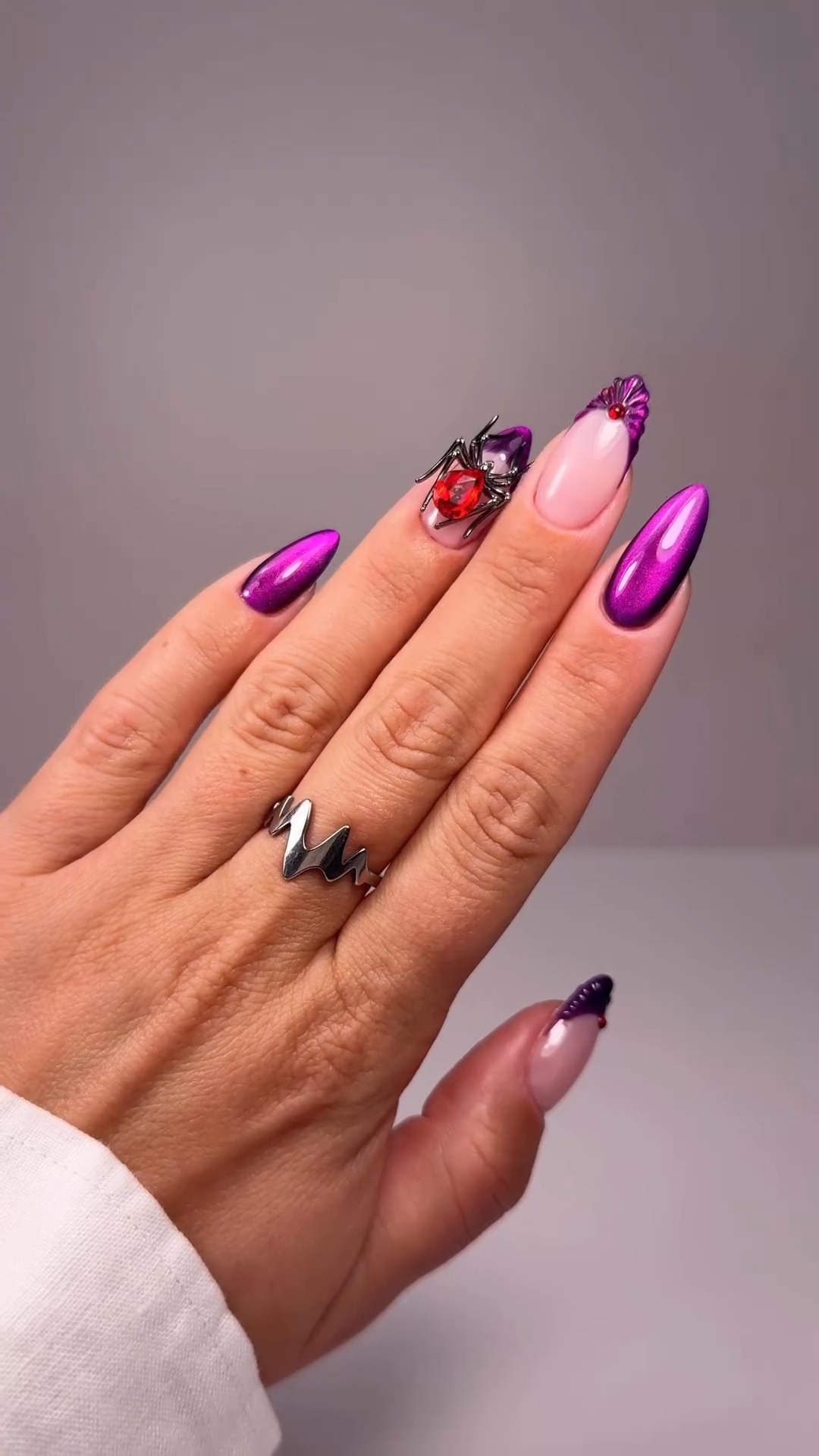 Instagram post by @beetles_community for BeetlesGelPolish. Caption reads: Spooky but make it glam 💜🕷️✨
💅Nail design by....