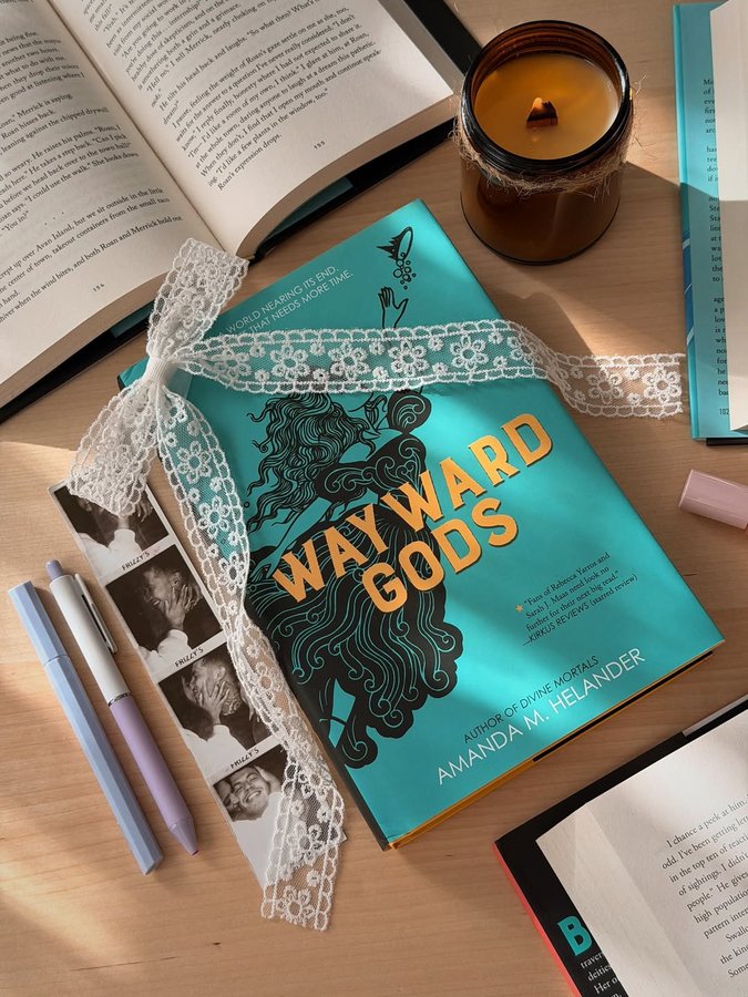 Instagram post by @alexarayeslibrary for Disney Publishing Worldwide. Caption reads: My next read!! 📚✨🍂💕 Wayward Gods by Amanda M.....