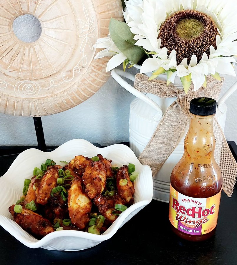 Instagram post by @sleekjules_reviews for BzzAgent. Caption reads: FRANK'S RedHot Wings Sauce has become a tasty....