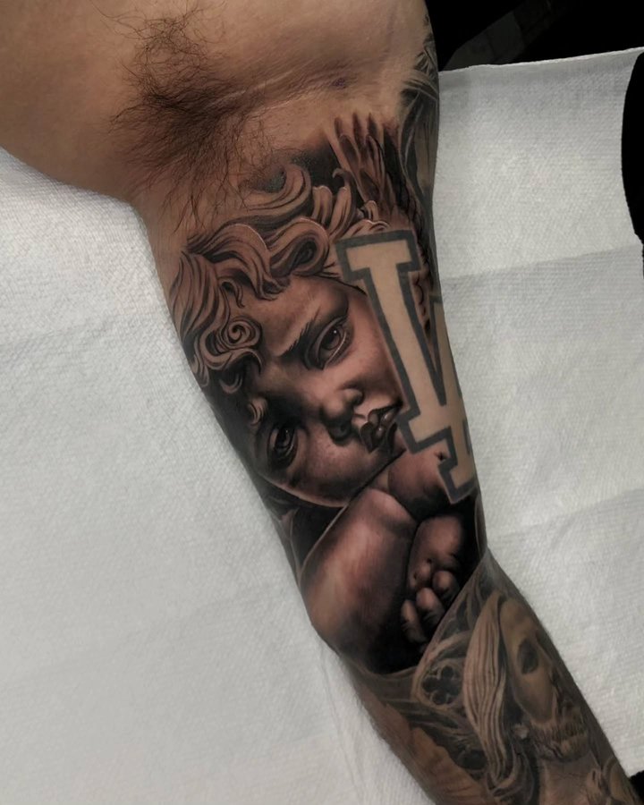 Instagram post by @mager_tattoos for Affirm. Caption reads: Cherub to finish this sleeve | Text (877)503-2977....