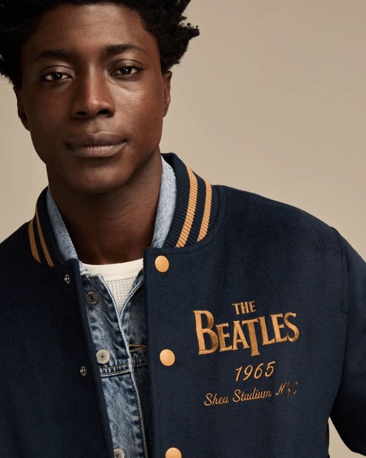Instagram post by @thebeatles for Lucky Brand. Caption reads: Inspired by icons, our new varsity jacket hits....
