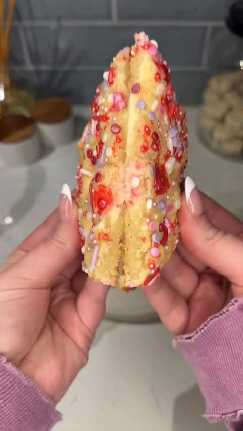 Instagram post by @ashleymarkletreats for Hersheyland. Caption reads: these cheesecake stuffed sugar cookies are so easy....