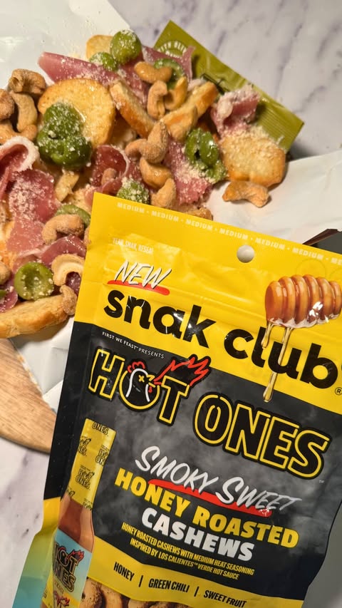 Instagram post by @snakclub for First We Feast. Caption reads: Stack it. Snack it. Power through it 💪 #SnakClub....