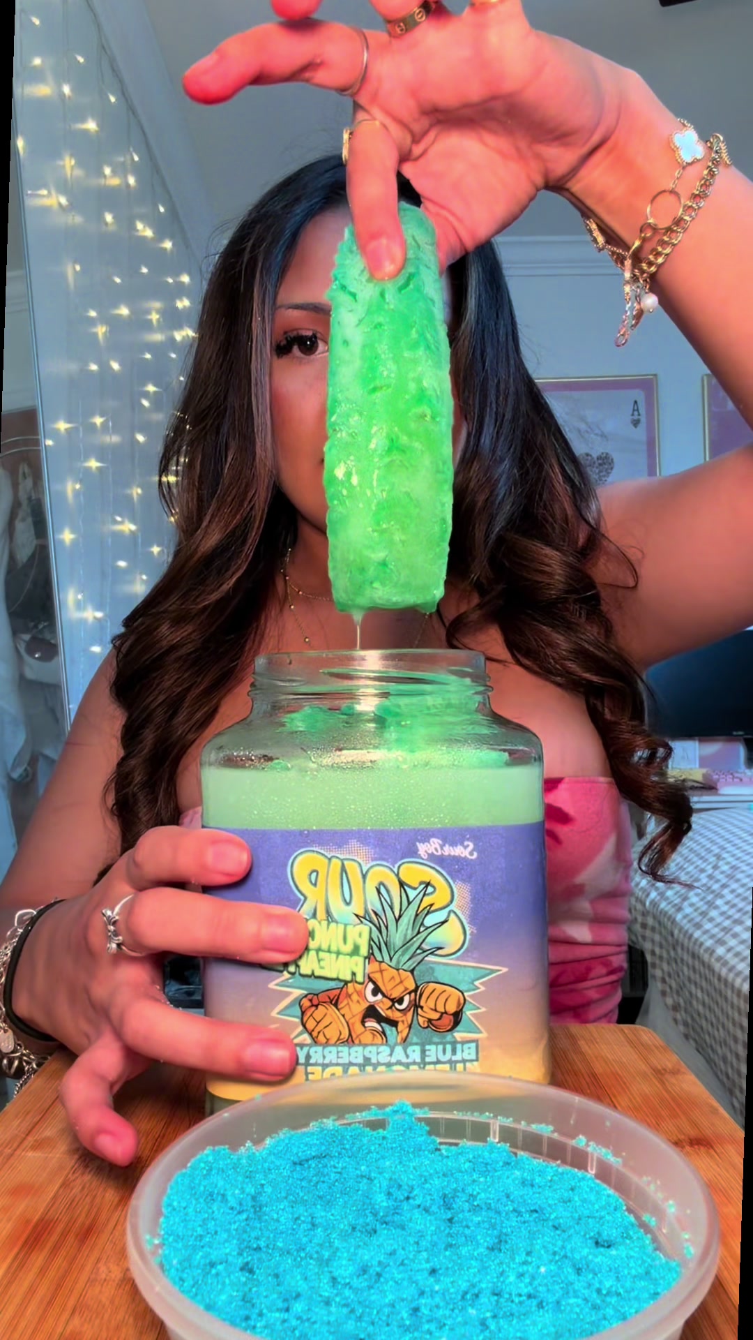 TikTok post by @lilah.eats for Sourboy Snacks. Caption reads: Trying the POPULAR Kool Aid Pineapple Spears🍍I....