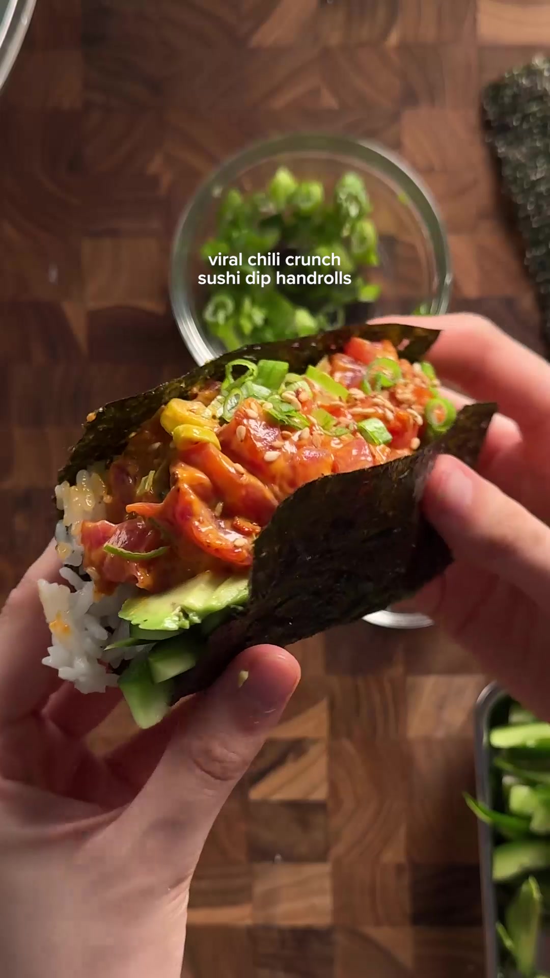 TikTok post by @emijuju for Momofuku. Caption reads: @Momofuku viral chili crunch sushi dip hand rolls....