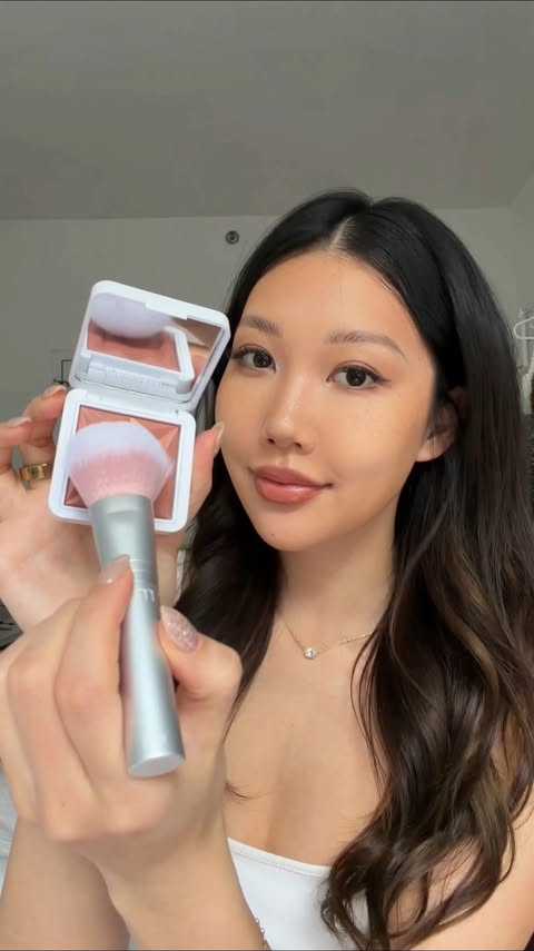 Instagram post by @emilythebearrr for RMS Beauty. Caption reads: The secret is out… add natural glow to your cheeks....