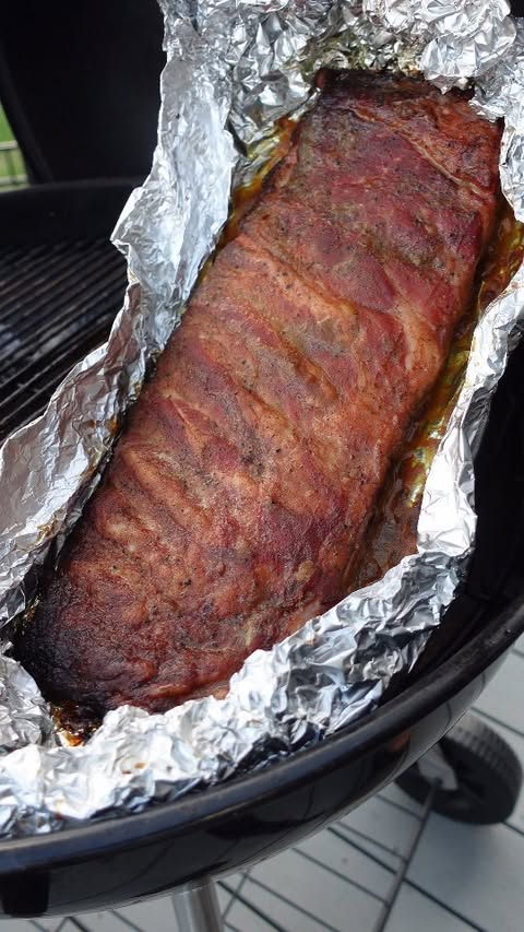 Instagram post by @smoke_stone_cuisine for SNS Grills. Caption reads: 🐷 SPG Ribs with South Carolina Mustard Sauce....