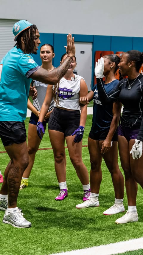 Instagram post by @playfootball for Baptist Health. Caption reads: Coach Ollie pulled up to our girls flag clinic 😎....