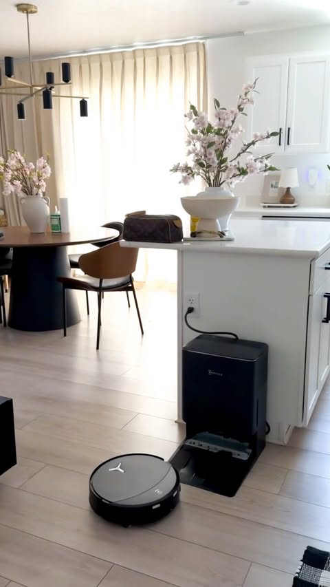 Instagram post by @karinabbingham for ECOVACS ROBOTICS. Caption reads: Keeping my home clean has never been easier! #ad....