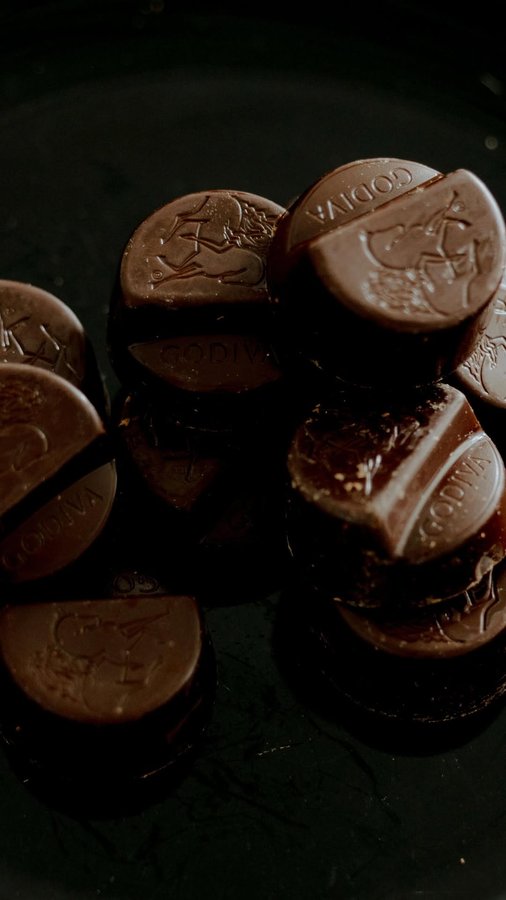 Instagram post by @xxjmitch for Godiva. Caption reads: [...] in the spotlight, a frame in bloom, and....