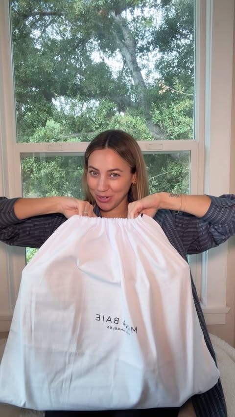 Instagram post by @cammiescott for MINA BAIE. Caption reads: unboxing my dream diaper bag @minabaie #minabaie....