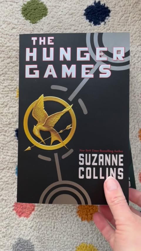 Instagram post by @storymamas for Scholastic. Caption reads: [...] #storymamasbookaday #hungergames @scholastic....