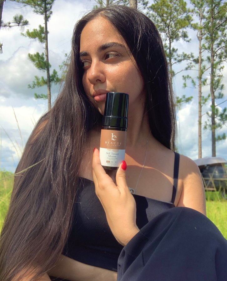 Instagram post by @dsgner99 for Beauty By Earth. Caption reads: Self Tanner Mousse from @beautybyearth....