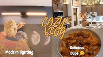 YouTube post by @JustSimplyRose for BODEGAcooler. Caption reads: Home Vlog- Cozy Modern lighting updates- Delicious....