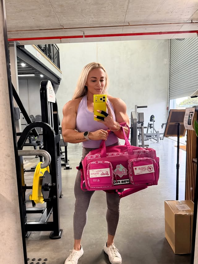 Instagram post by @suzan_oktay_ifbbpro for WOLFpak. Caption reads: [...] Obsessed with my new pink duffle from....