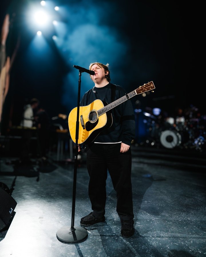 Instagram post by @lewiscapaldi for HEYDUDE. Caption reads: Tour’s done, slippers are on. @lewiscapaldi is....
