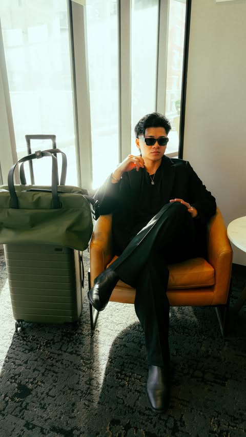 Instagram post by @flywithjohnnythai for Away. Caption reads: #AwayPartner Pack with me for a video shoot ✈️....