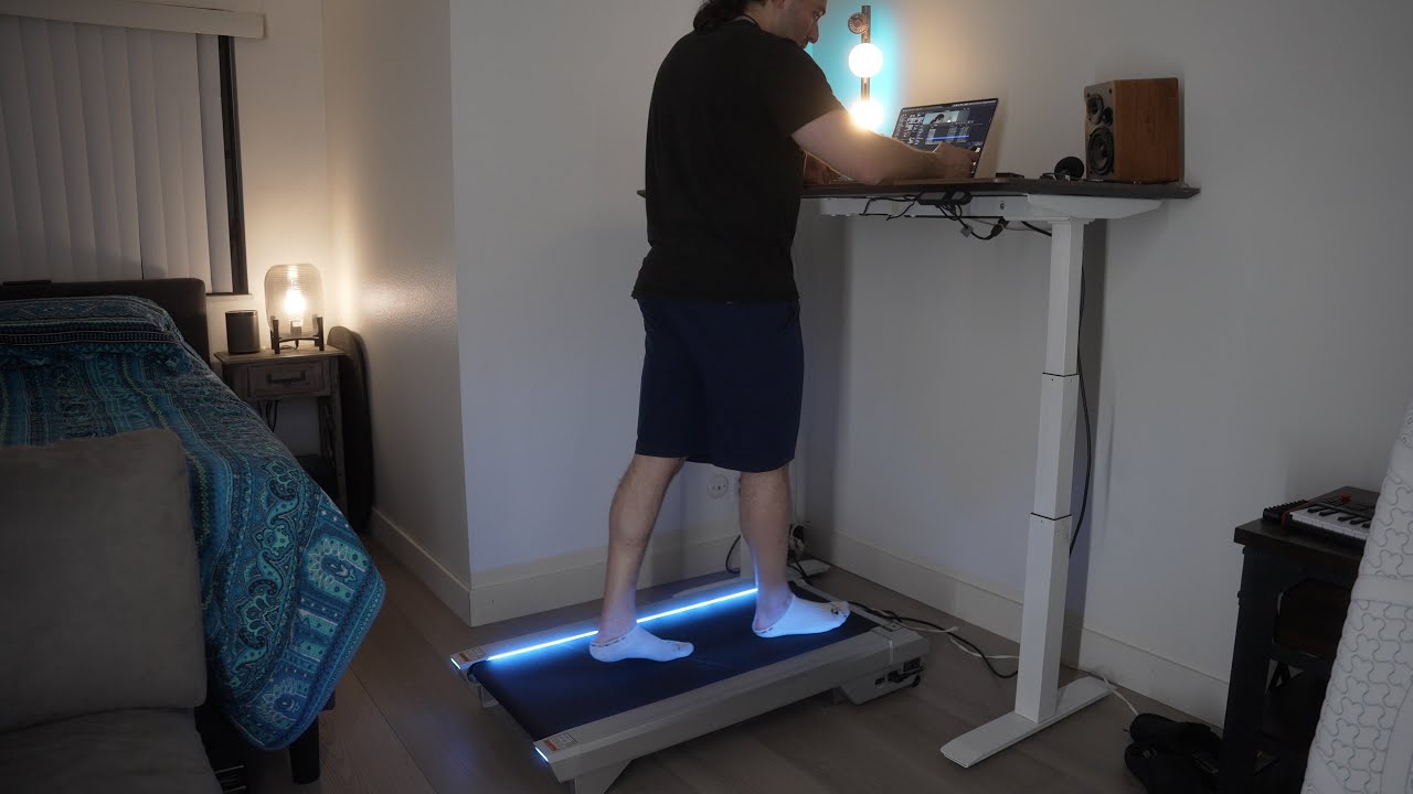 YouTube post by @MomentumProductions1992 for B&H Photo Video. Caption reads: Work + Walk? UREVO Cyberpad Treadmill Desk Tested!.