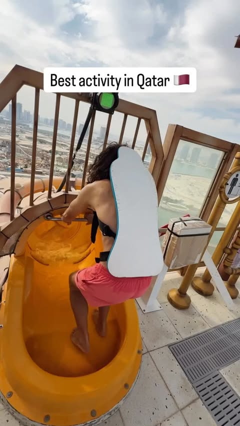 Instagram post by @traveltomtom for Visit Qatar. Caption reads: ad The world’s tallest waterslide is in Qatar,....