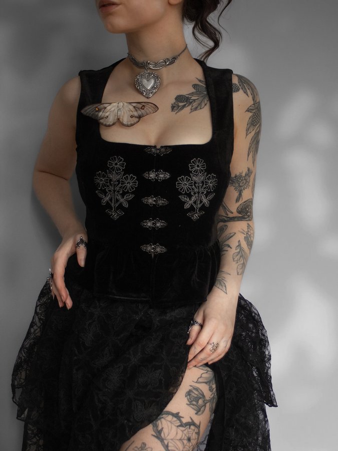 Instagram post by @weirdolini for DISTURBIA. Caption reads: shadows and winged lace 🗡️

A silent witness sits....