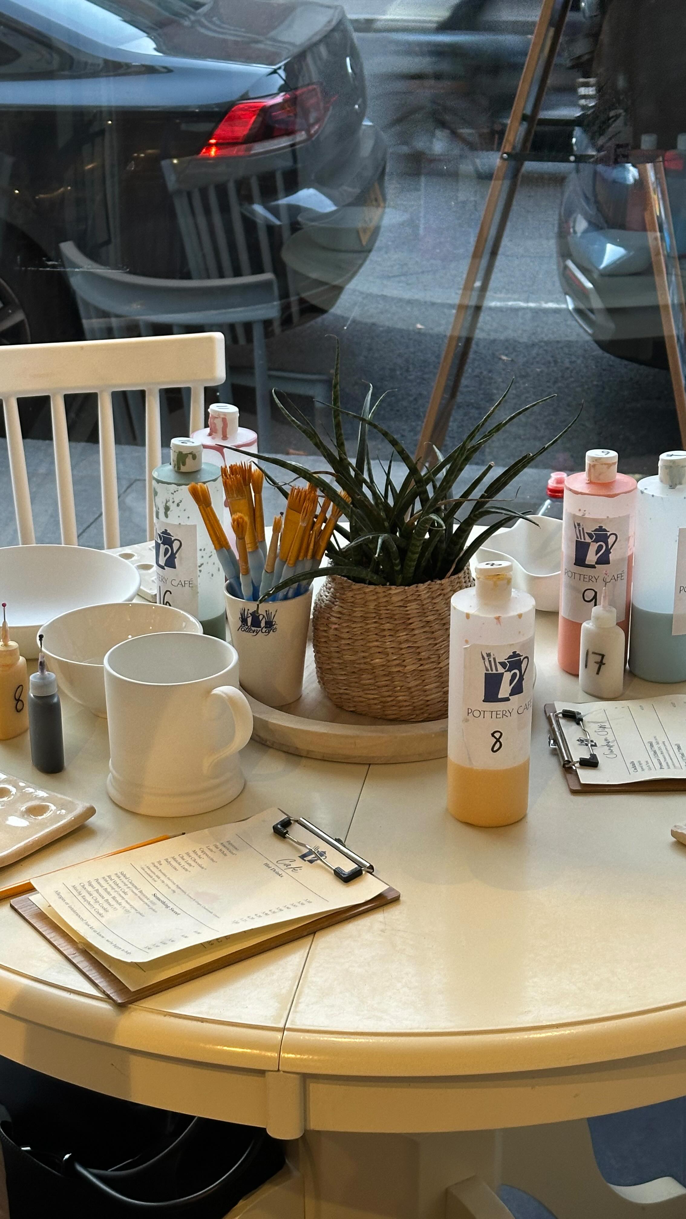 Instagram post by @gee__eats for Pottery Café. Caption reads: ad | adult-only pottery painting evenings in....