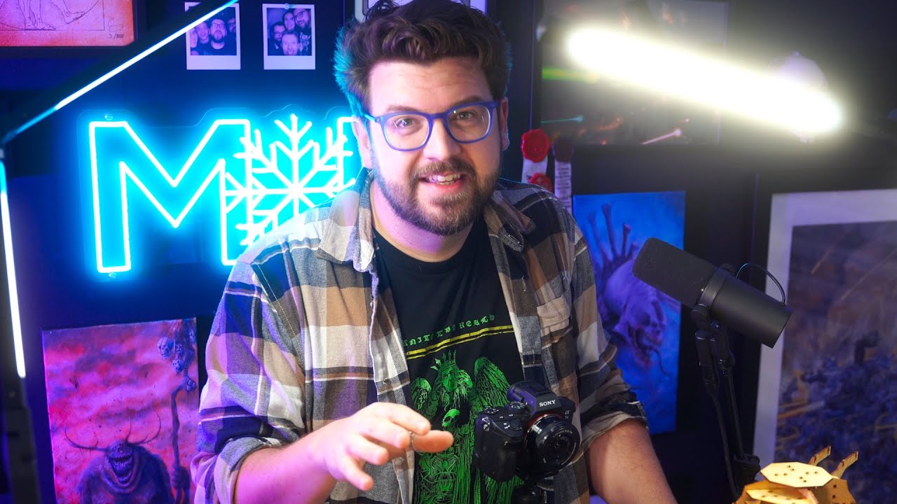 YouTube post by @MidwinterMinis for JustGiving. Caption reads: Channel update: my a** exploded / Henry Cavill....