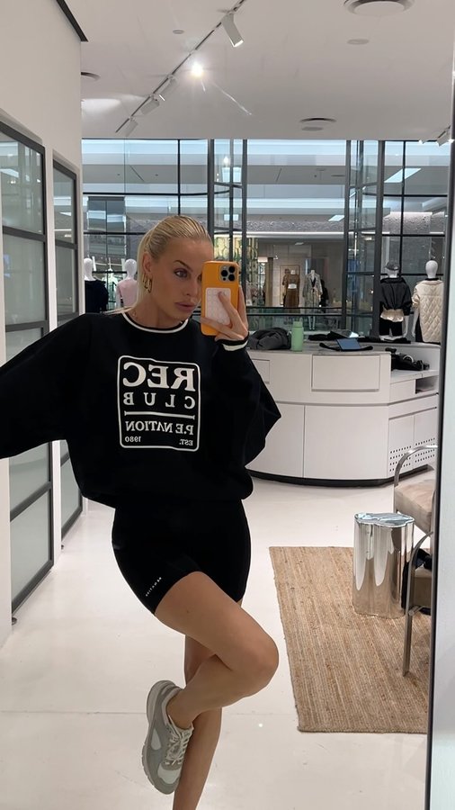 Instagram post by @bellawolfgang for P.E Nation. Caption reads: New @p.e.nation activewear 🤝 workout motivation.