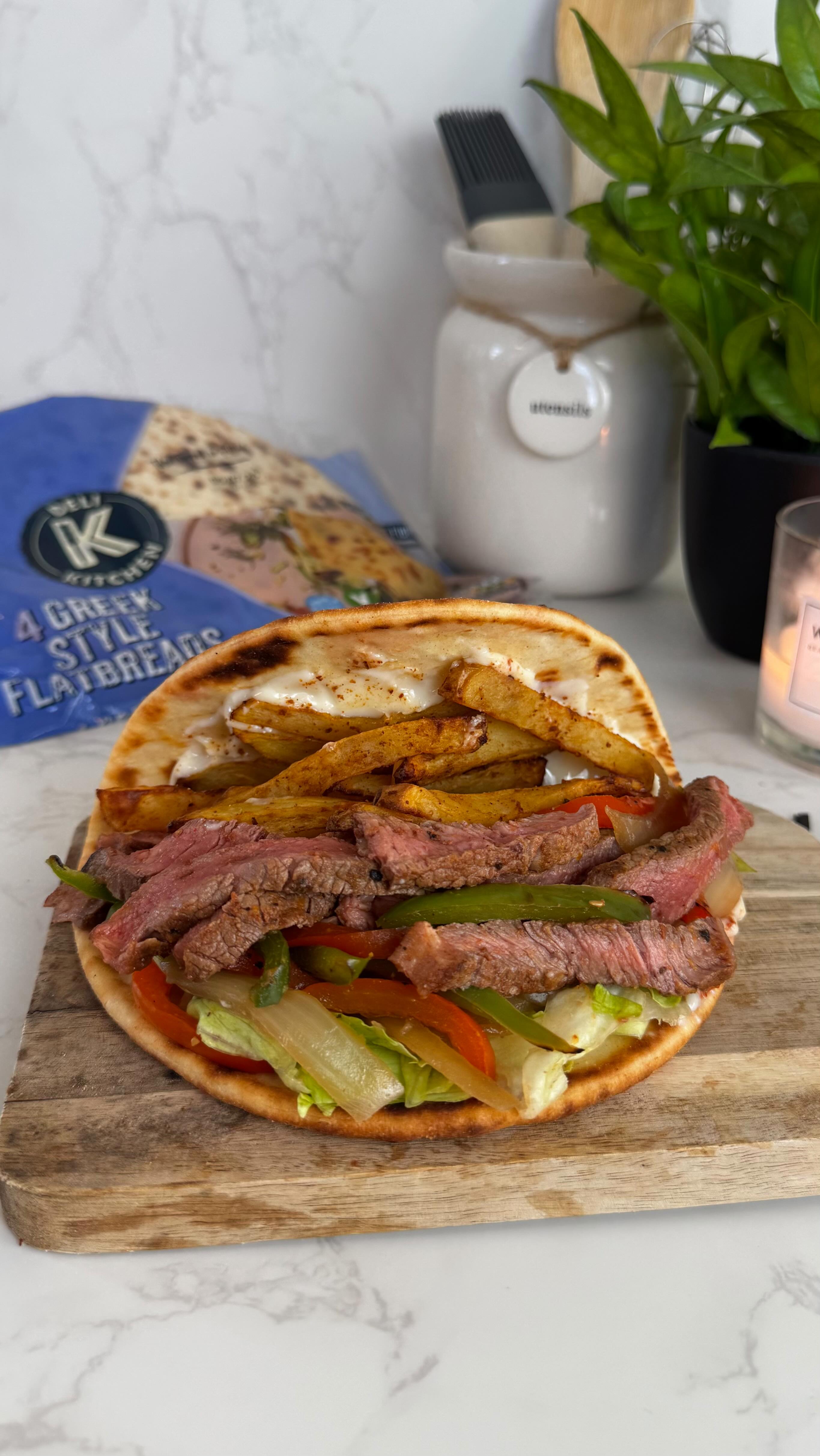 Instagram post by @slimming.gym.and.gin for MyFitnessPal. Caption reads: AD | PHILLY CHEESESTEAK & CHIPS ON A FLATBREAD? Oh....